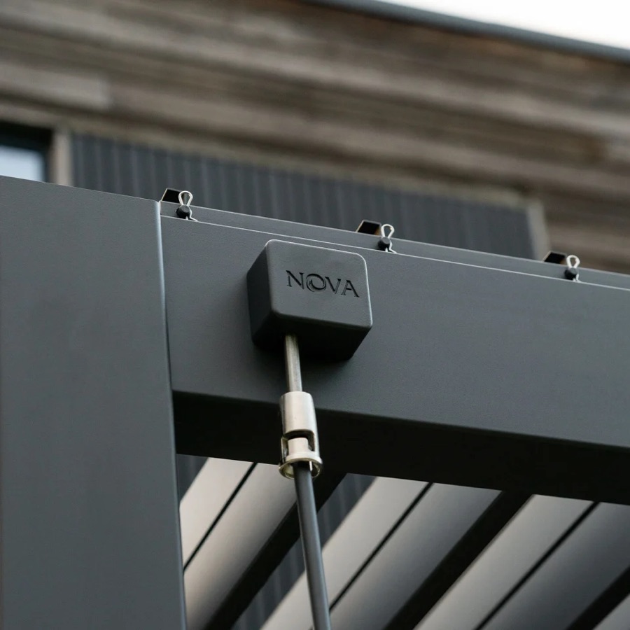 Close-up of the branded louvre drive housing on the anthracite frame of a Nova Titan pergola